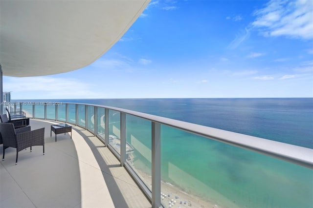 balcony with a water view and a beach view