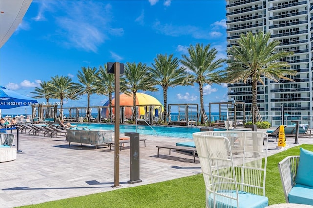 view of swimming pool featuring a patio and a yard