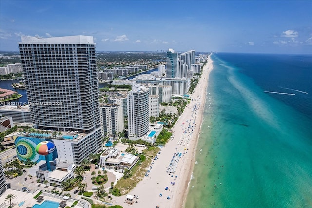 bird's eye view with a water view and a beach view