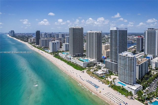 drone / aerial view with a water view and a beach view