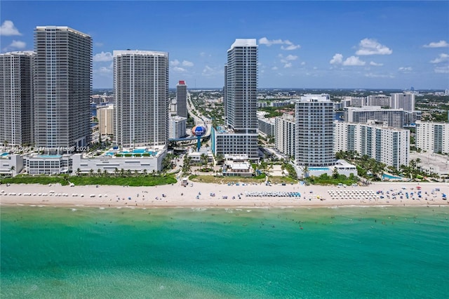 bird's eye view featuring a water view and a beach view