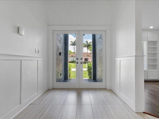 doorway to outside featuring french doors and light hardwood / wood-style flooring