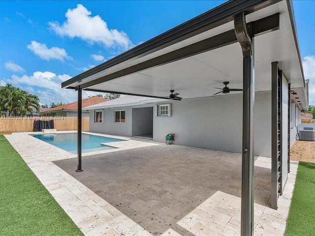 view of swimming pool with ceiling fan, cooling unit, and a patio area