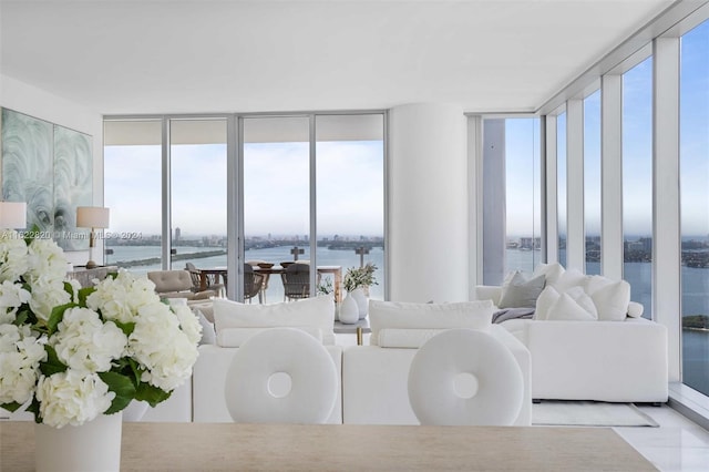 living room with floor to ceiling windows and a water view