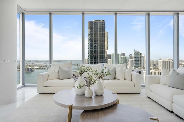 living room featuring a water view and floor to ceiling windows