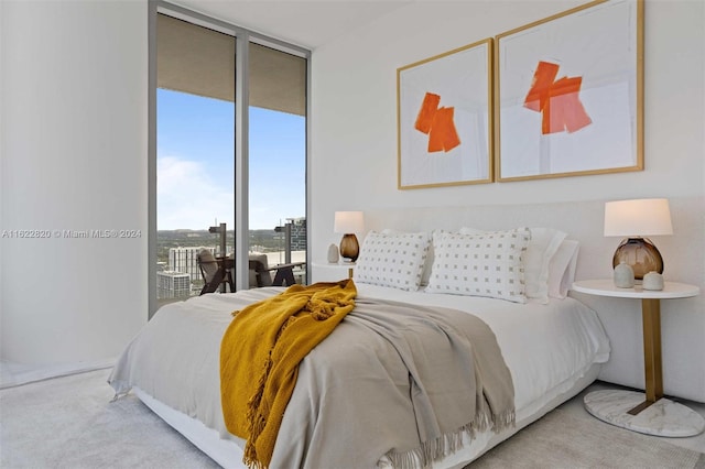 carpeted bedroom featuring access to outside and a wall of windows