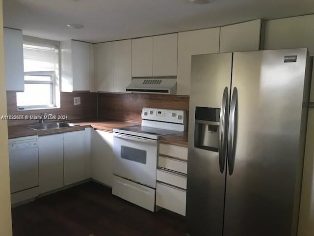 kitchen featuring extractor fan, dark hardwood / wood-style floors, white cabinets, white appliances, and sink