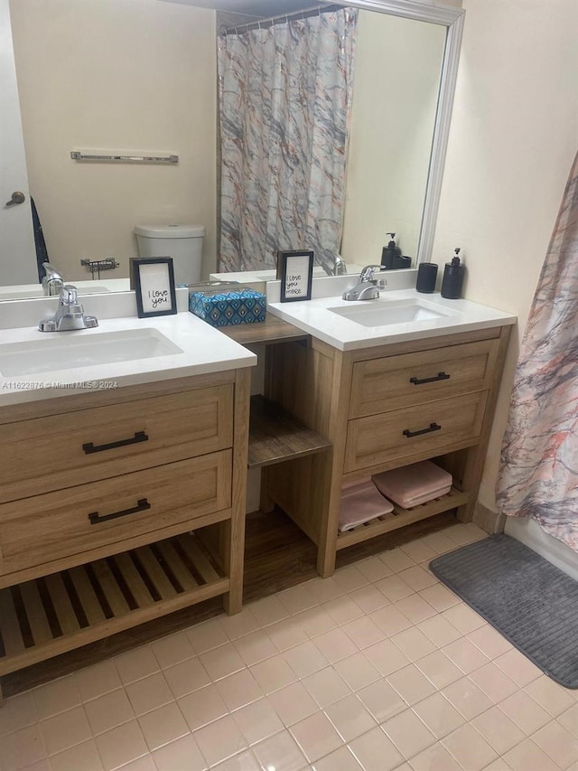 bathroom with tile patterned floors, vanity, and toilet