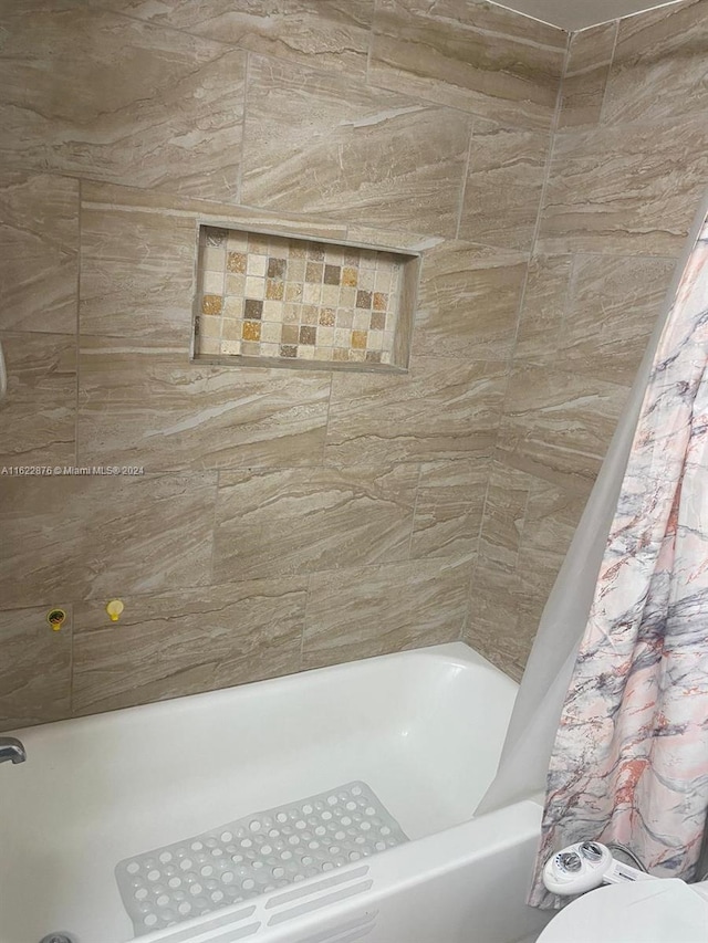 bathroom featuring shower / bath combination with curtain