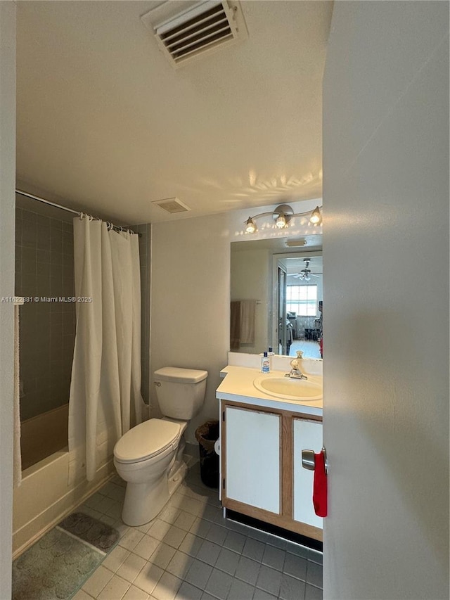 full bathroom with shower / tub combo with curtain, vanity, tile patterned floors, and toilet