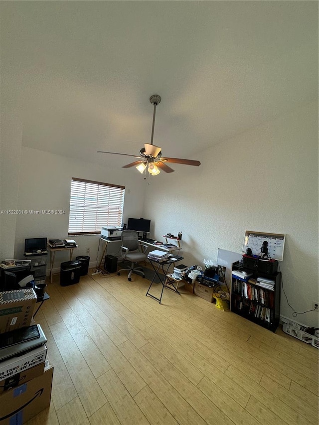 office area with light wood-type flooring and ceiling fan