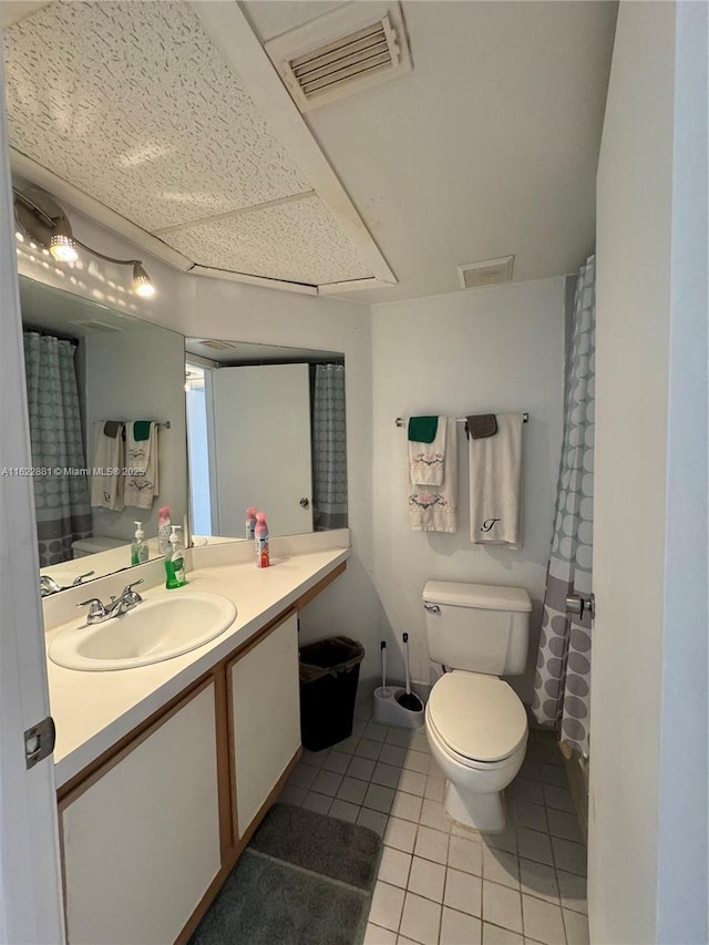 bathroom featuring vanity, toilet, and tile patterned flooring