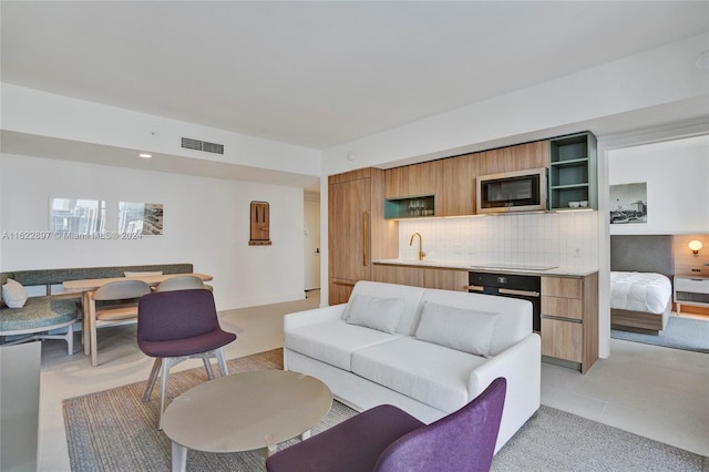 tiled living room featuring sink