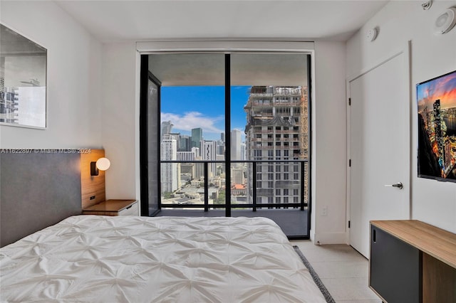 tiled bedroom featuring access to outside and expansive windows