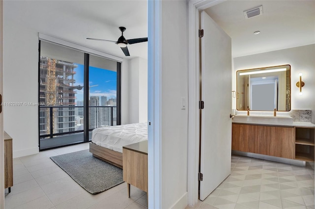 bedroom with light tile patterned flooring, ceiling fan, and access to exterior