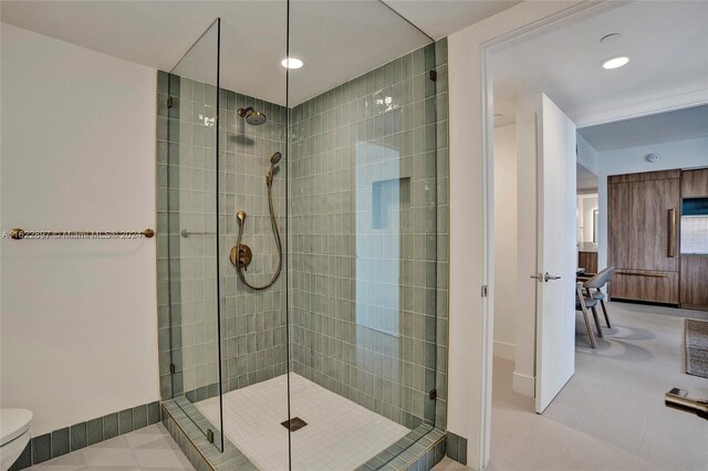 bathroom with a shower with shower door, toilet, and tile patterned floors