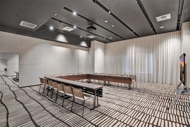 recreation room with light colored carpet