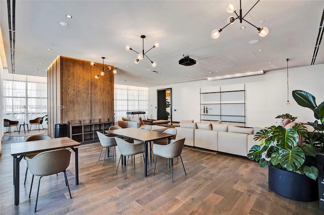 dining space featuring a chandelier, hardwood / wood-style flooring, and a wall of windows