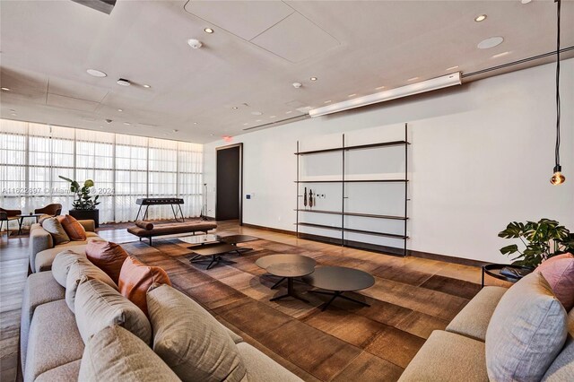 living room with dark hardwood / wood-style flooring and floor to ceiling windows