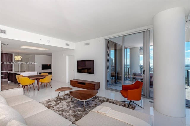 living room with floor to ceiling windows and light tile patterned flooring