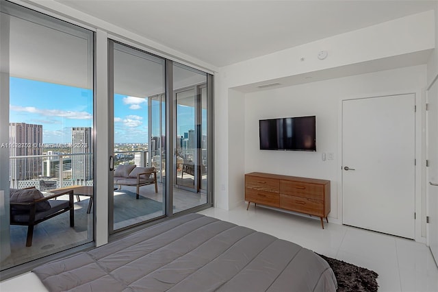 bedroom with expansive windows, light tile patterned floors, and access to outside