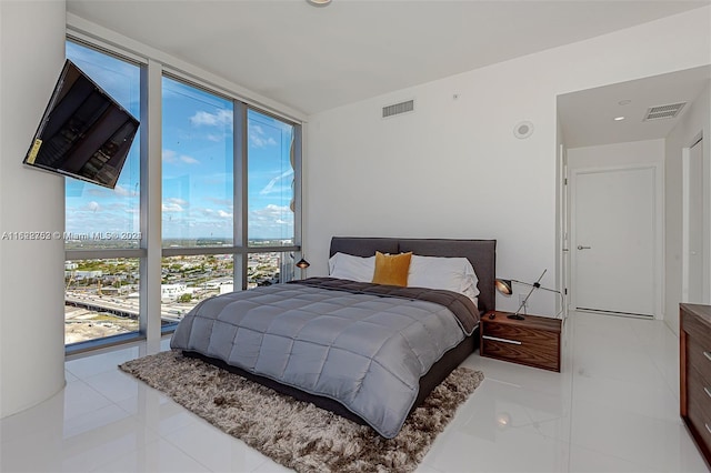 tiled bedroom featuring floor to ceiling windows