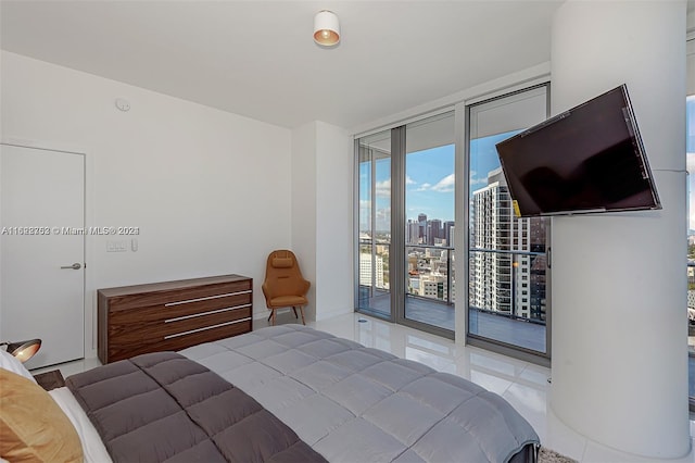 tiled bedroom featuring access to exterior and a wall of windows