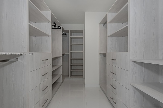 spacious closet with light tile patterned flooring