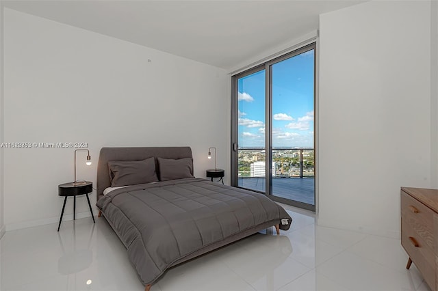 bedroom featuring access to outside, expansive windows, and light tile patterned floors