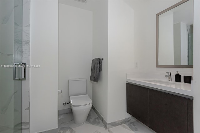 bathroom featuring vanity, toilet, and a shower with shower door