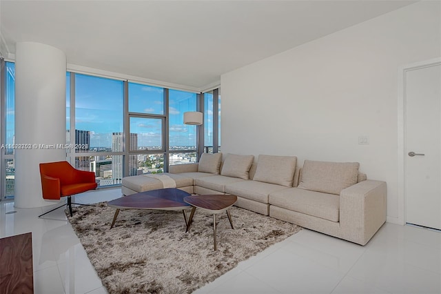 living room featuring tile patterned floors and a wall of windows