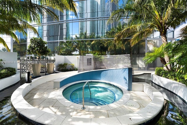 view of swimming pool featuring an in ground hot tub