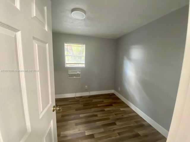 spare room featuring dark hardwood / wood-style flooring