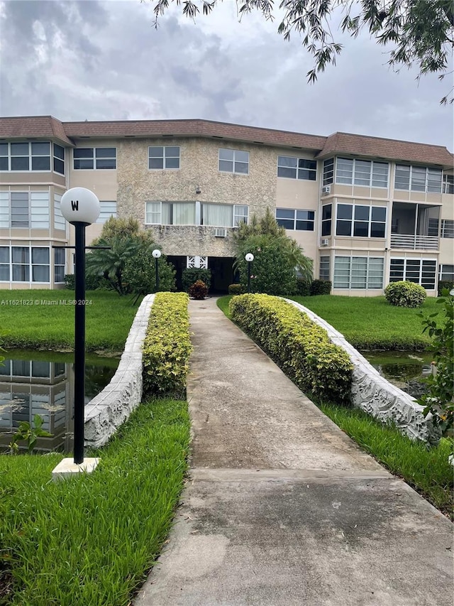 view of home's community with a lawn