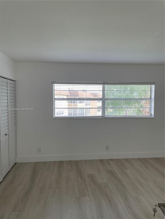 unfurnished room with wood-type flooring and plenty of natural light