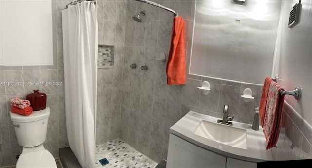 bathroom featuring tile walls, toilet, vanity, and a shower with shower curtain