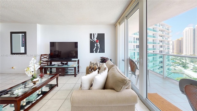 living room featuring a textured ceiling and light tile patterned floors