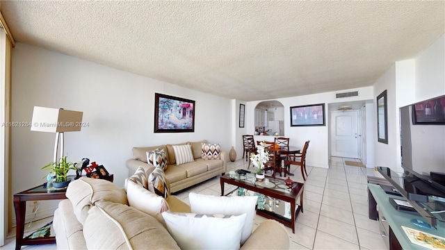 tiled living room with a textured ceiling