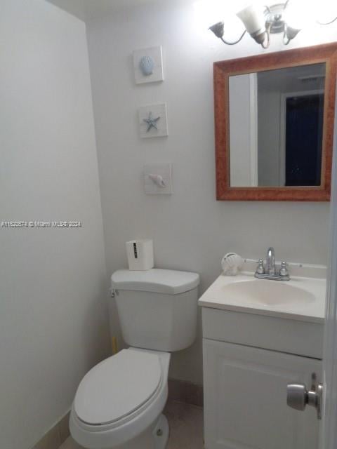 bathroom with vanity, toilet, and tile patterned floors