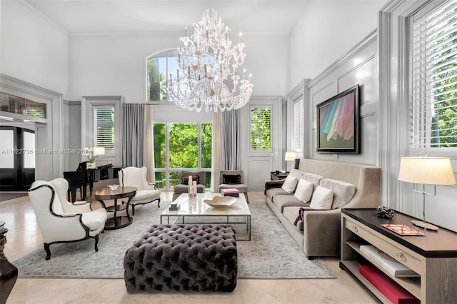 interior space with a notable chandelier, ornamental molding, and a towering ceiling