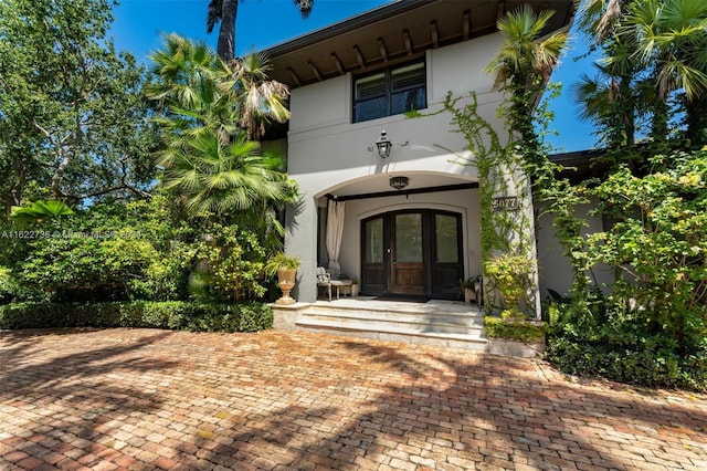 view of exterior entry featuring french doors