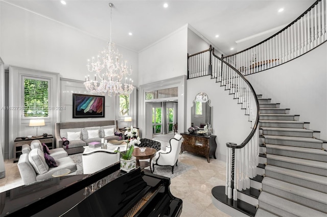 living room with crown molding, a high ceiling, and a notable chandelier