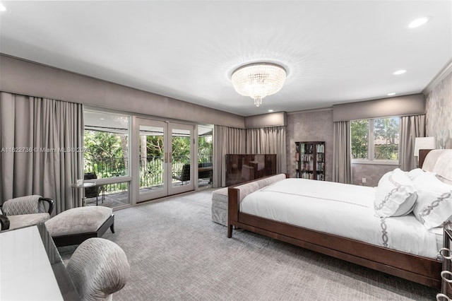 carpeted bedroom with access to exterior, french doors, and a chandelier