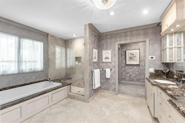 bathroom featuring crown molding, vanity, and shower with separate bathtub