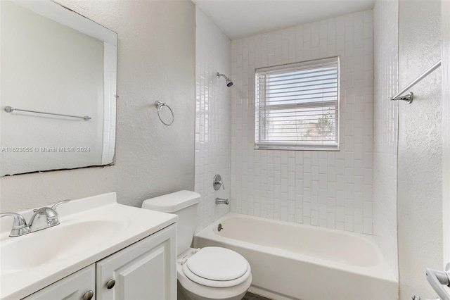 full bathroom featuring vanity, toilet, and tiled shower / bath