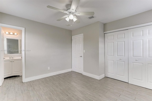 unfurnished bedroom featuring light hardwood / wood-style flooring and a closet