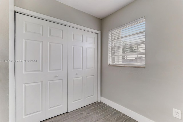 unfurnished bedroom featuring a closet and light hardwood / wood-style floors