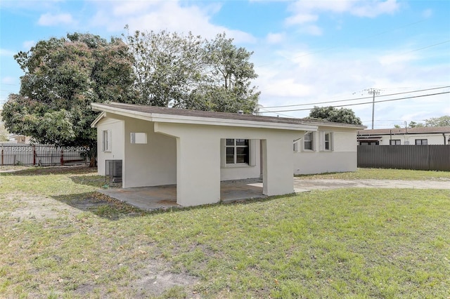 back of house with a yard, central AC, and a patio area