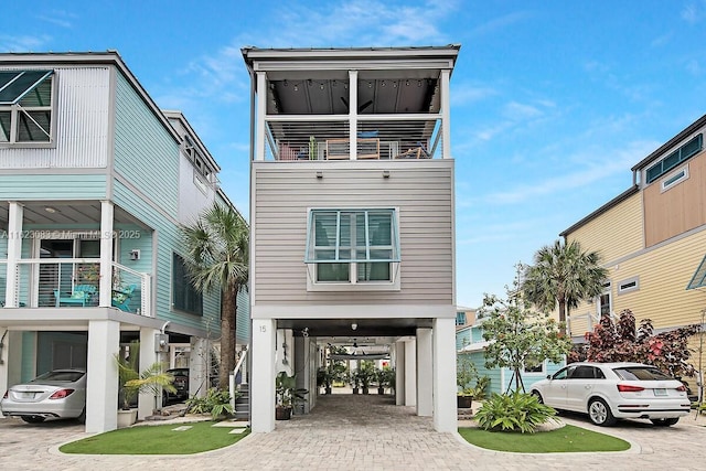 view of front of property featuring a balcony and a carport