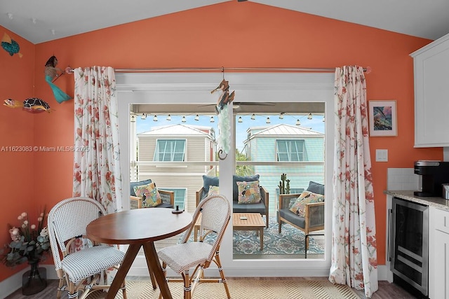 dining room with beverage cooler and vaulted ceiling